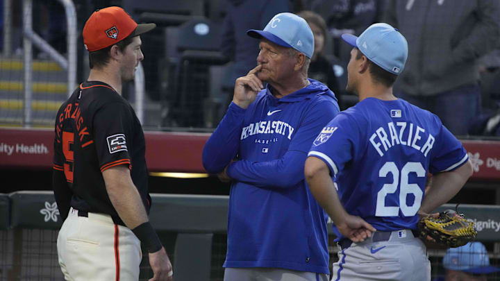Mar 19, 2024; Scottsdale, Arizona, USA; San Francisco Giants center fielder Mike Yastrzemski (5), Kansas City Royals left fielder Adam Frazier (26) and George Brett talk before a game at Scottsdale Stadium.