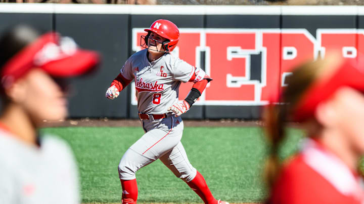 Abbie Squier (8) rounds the bases after hitting a three-run homer. 