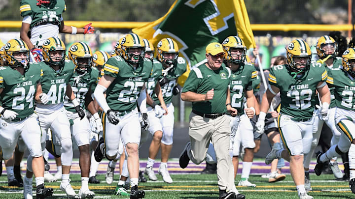 St. Edward head coach Tom Lombardo leads the team onto the field for a game against River rouge (Michigan) on September 23, 2024.