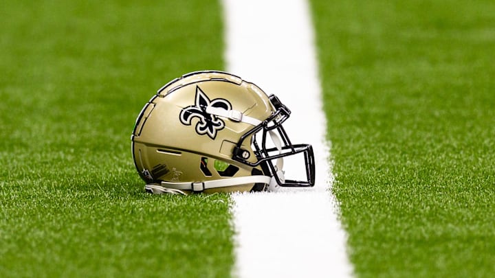 Aug 25, 2024; New Orleans, Louisiana, USA;  New Orleans Saints helmet on the turf during warmups before the game against the Tennessee Titans at Caesars Superdome. Mandatory Credit: Stephen Lew-Imagn Images