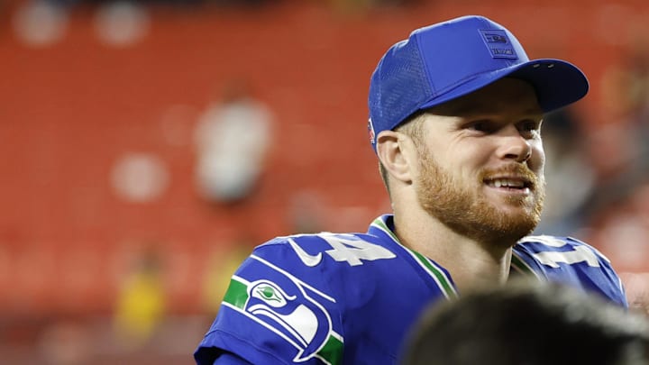 Nov 2, 2025; Landover, Maryland, USA; Seattle Seahawks quarterback Sam Darnold (14) smiles while leaving the field after the game against the Washington Commanders at Northwest Stadium.