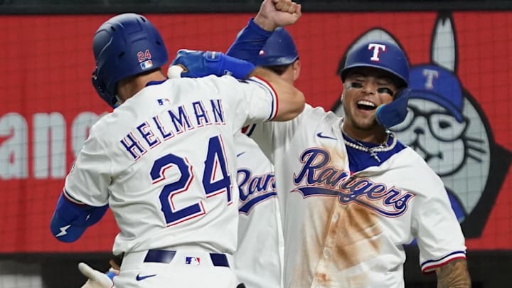 July 21, 2025; Arlington, Texas, USA; Texas Rangers outfielder Micheal Helman (24) elbow bumps Texas Rangers designated hitter Cody Freeman (39) after hitting a three-run home run at Globe Life Field. Helman collected his first MLB home run and Freeman his first MLB hit both in the fifth inning against the Athletics. 