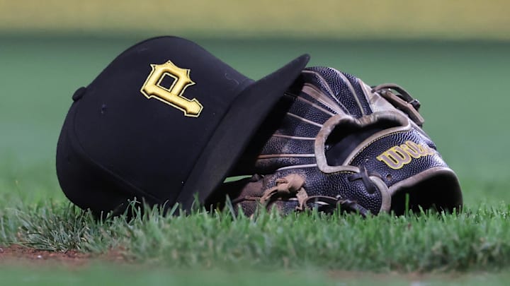 Sep 16, 2025; Pittsburgh, Pennsylvania, USA; A hat and glove belonging to Pittsburgh Pirates third baseman Jared Triolo (not pictured) on the field against the Chicago Cubs during the sixth inning at PNC Park. Mandatory Credit: Charles LeClaire-Imagn Images Sep 16, 2025; Pittsburgh, Pennsylvania, USA; A hat and glove belonging to Pittsburgh Pirates third baseman Jared Triolo (not pictured) on the field against the Chicago Cubs during the sixth inning at PNC Park. Mandatory Credit: Charles LeClaire-Imagn Images