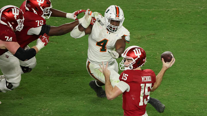 Indiana Hoosiers quarterback Fernando Mendoza (15) passes the ball under pressure by Miami Hurricanes defensive lineman Rueben Bain Jr. (4) in the third quarter during the College Football Playoff National Championship game at Hard Rock Stadium. Indiana Hoosiers quarterback Fernando Mendoza (15) passes the ball under pressure by Miami Hurricanes defensive lineman Rueben Bain Jr. (4) in the third quarter during the College Football Playoff National Championship game at Hard Rock Stadium.