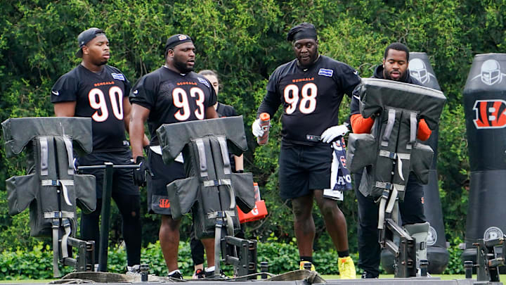 Cincinnati Bengals defensive tackle B.J. Hill (92) demonstrates a drill to teammates during practice, Tuesday, May 6, 2025, at the Kettering Health Practice Field in Downtown Cincinnati.