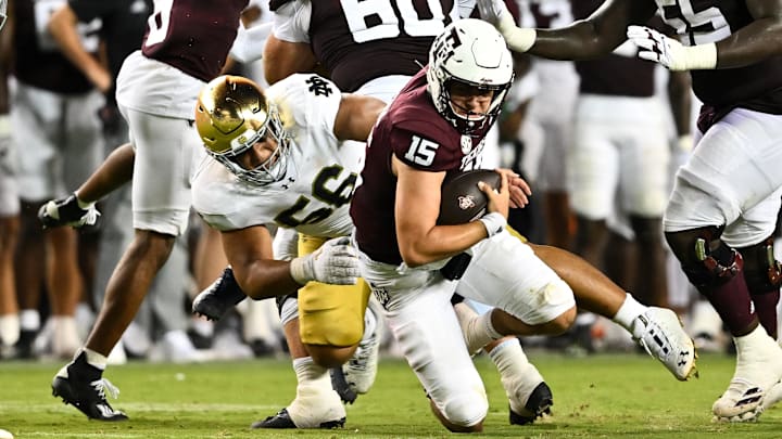 Aug 31, 2024; College Station, Texas, USA; Notre Dame Fighting Irish defensive lineman Howard Cross III (56) tackles Texas A&M Aggies quarterback Conner Weigman (15) at Kyle Field.