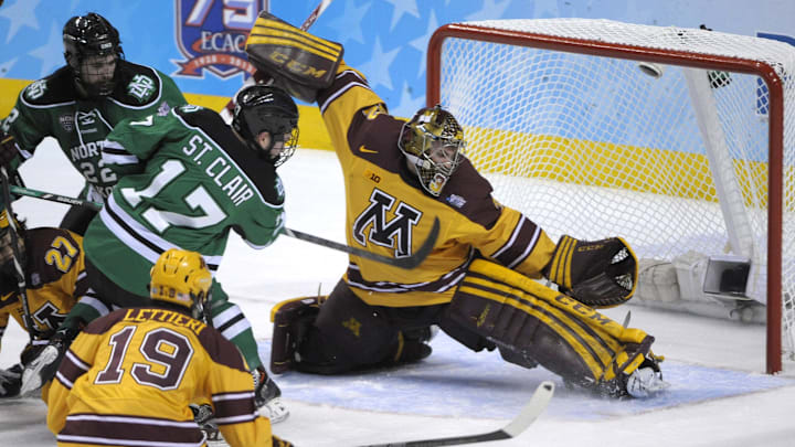 Apr 10, 2014; Philadelphia, PA, USA; Minnesota Gophers goaltender Adam Wilcox (32) makes a save against North Dakota Sioux forward Colten St. Clair (17) during the first period in the semifinals of the Frozen Four college ice hockey tournament at Wells Fargo Center. 