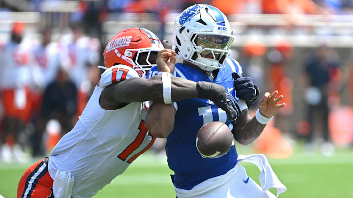 Sep 6, 2025; Durham, North Carolina, USA;  Illinois Fighting Illini linebacker Gabe Jacas (17) swats the ball from Duke Blue Devils quarterback Darian Mensah (10) during the second quarter at Wallace Wade Stadium. Mandatory Credit: Zachary Taft-Imagn Images