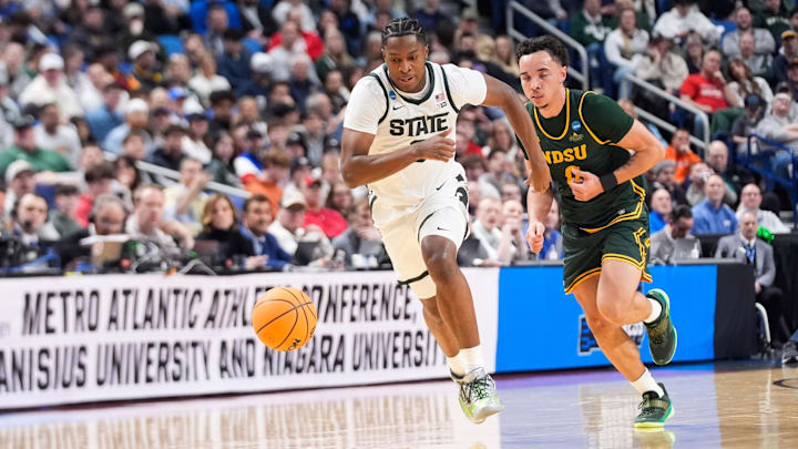 Mar 19, 2026; Buffalo, NY, USA; Michigan State Spartans forward Cameron Ward (3) and North Dakota State Bison guard Trevian Carson (0) chase a loose ball during the first half during a first round game of the men's 2026 NCAA Tournament at Keybank Center. Mandatory Credit: Gregory Fisher-Imagn Images Mar 19, 2026; Buffalo, NY, USA; Michigan State Spartans forward Cameron Ward (3) and North Dakota State Bison guard Trevian Carson (0) chase a loose ball during the first half during a first round game of the men's 2026 NCAA Tournament at Keybank Center. Mandatory Credit: Gregory Fisher-Imagn Images