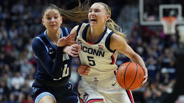 Mar 9, 2025; Uncasville, CT, USA; UConn Huskies guard Paige Bueckers (5) drives the ball against Villanova Wildcats guard Dani Ceseretti (24) in the first half at Mohegan Sun Arena. Mandatory Credit: David Butler II-Imagn Images Mar 9, 2025; Uncasville, CT, USA; UConn Huskies guard Paige Bueckers (5) drives the ball against Villanova Wildcats guard Dani Ceseretti (24) in the first half at Mohegan Sun Arena. Mandatory Credit: David Butler II-Imagn Images