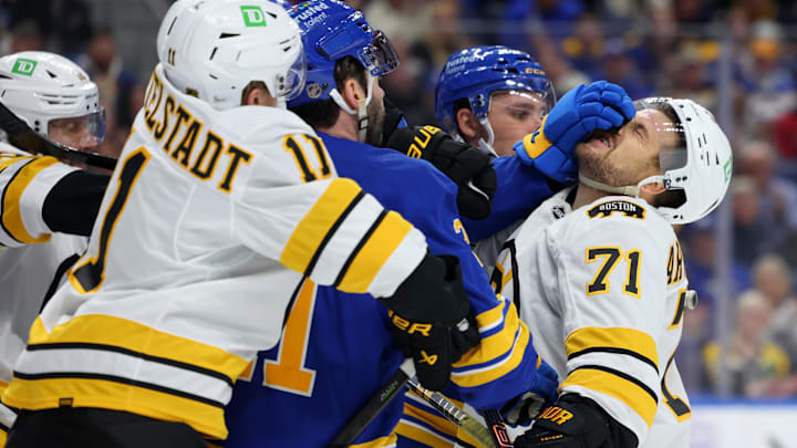 Mar 25, 2026; Buffalo, New York, USA;  The Boston Bruins and the Buffalo Sabres players get into a scrum after the whistle during the first period at KeyBank Center. Mandatory Credit: Timothy T. Ludwig-Imagn Images
