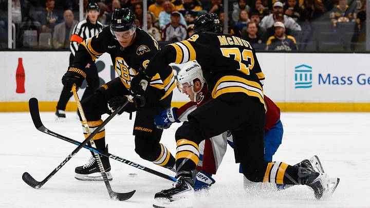 Oct 25, 2025; Boston, Massachusetts, USA; Colorado Avalanche center Nathan MacKinnon (29) gets caught between Boston Bruins defenseman Charlie McAvoy (73) and defenseman Nikita Zadorov (91) going for a loose puck during the first period at TD Garden. Mandatory Credit: Winslow Townson-Imagn Images