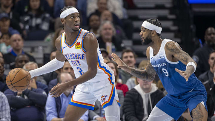 Oklahoma City Thunder guard Shai Gilgeous-Alexander is guarded by Minnesota Timberwolves guard Nickeil Alexander-Walker