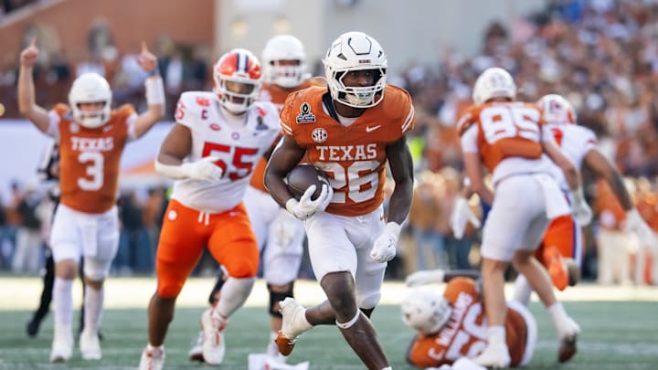 Dec 21, 2024; Austin, Texas, USA; Texas Longhorns running back Quintrevion Wisner (26) scores a touchdown against the Clemson Tigers during the first half of the CFP National playoff first round at Darrell K Royal-Texas Memorial Stadium. Mandatory Credit: Mark J. Rebilas-Imagn Imagesmagn Images
