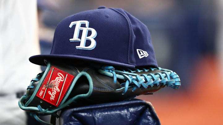 A detail view of a Tampa Bay Rays hat and glove at Tropicana Field in 2019.