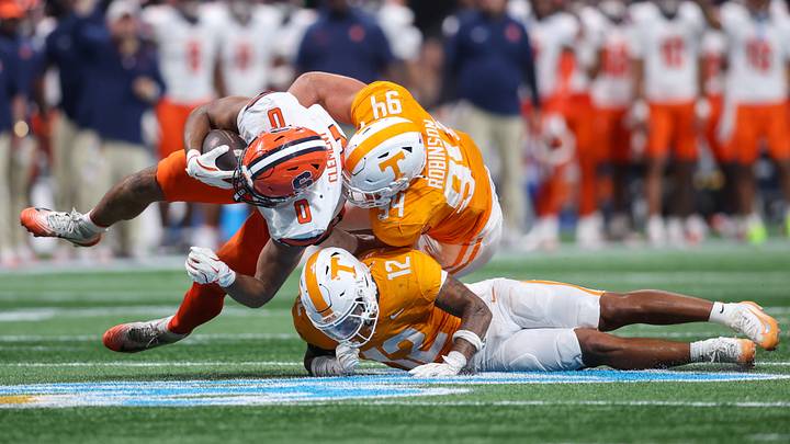 Aug 30, 2025; Atlanta, Georgia, USA; Syracuse Orange tight end David Clement (0) is tackled by Tennessee Volunteers linebacker Jaedon Harmon (12) and defensive lineman Nathan Robinson (94) in the fourth quarter at Mercedes-Benz Stadium. Mandatory Credit: Brett Davis-Imagn Images Aug 30, 2025; Atlanta, Georgia, USA; Syracuse Orange tight end David Clement (0) is tackled by Tennessee Volunteers linebacker Jaedon Harmon (12) and defensive lineman Nathan Robinson (94) in the fourth quarter at Mercedes-Benz Stadium. Mandatory Credit: Brett Davis-Imagn Images