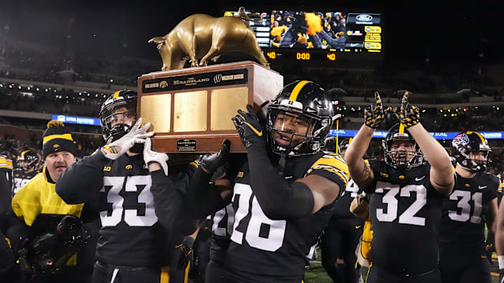 Iowa defensive backs Riley Moss, left, and Kaevon Merriweather carry the Heartland Trophy off the field after helping the Hawkeyes football team to a win over Wisconsin during a NCAA college football game in Iowa City on Saturday, Nov. 12, 2022.

Iowavswisconsin 20221112 Bh