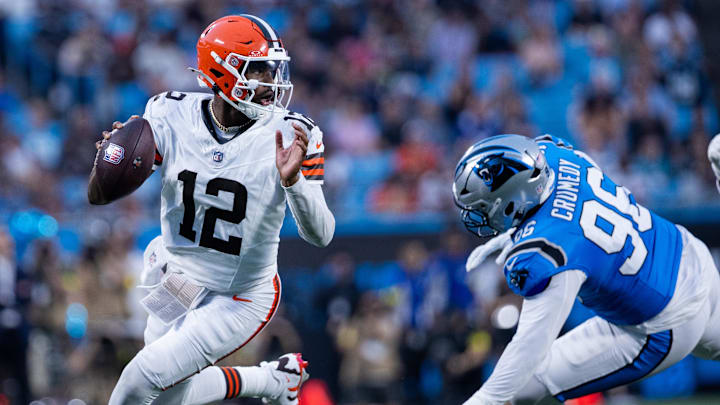 Aug 8, 2025; Charlotte, North Carolina, USA; Cleveland Browns quarterback Shedeur Sanders (12) gets away from Carolina Panthers defensive tackle Jaden Crumedy (96) during the second quarter at Bank of America Stadium. Mandatory Credit: Scott Kinser-The USAToday Network via Imagn Images 