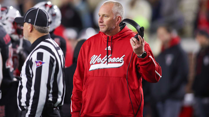 Nov 21, 2024; Atlanta, Georgia, USA; North Carolina State Wolfpack head coach Dave Doeren talks to a referee against the Georgia Tech Yellow Jackets in the fourth quarter at Bobby Dodd Stadium at Hyundai Field. Mandatory Credit: Brett Davis-Imagn Images