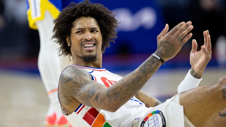 Mar 1, 2025; Philadelphia, Pennsylvania, USA; Philadelphia 76ers guard Kelly Oubre Jr. (9) reacts after being fouled during the second quarter against the Golden State Warriors at Wells Fargo Center. Mandatory Credit: Bill Streicher-Imagn Images
