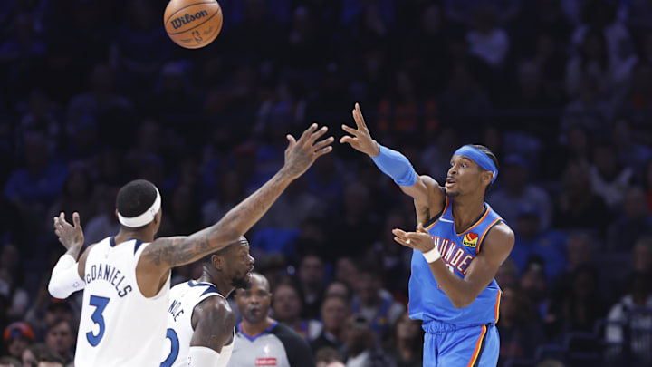 Dec 31, 2024; Oklahoma City, Oklahoma, USA; Oklahoma City Thunder guard Shai Gilgeous-Alexander (2) passes over Minnesota Timberwolves forward Jaden McDaniels (3) during the second quarter at Paycom Center. Mandatory Credit: Alonzo Adams-Imagn Images