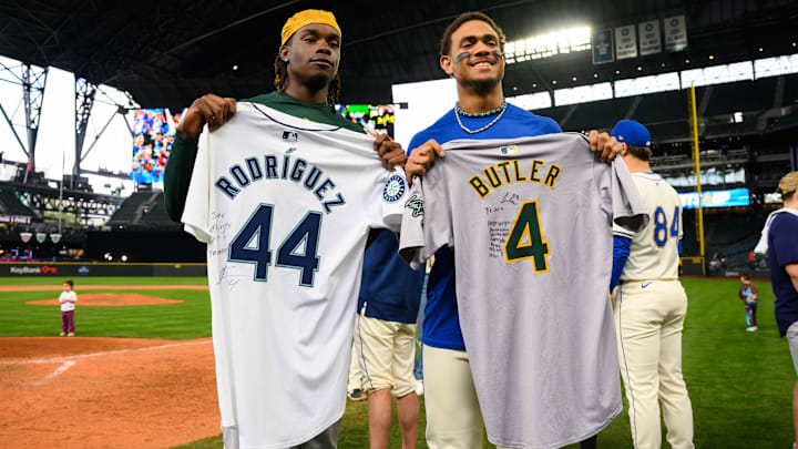 Sep 29, 2024; Seattle, Washington, USA; Oakland Athletics right fielder Lawrence Butler (4) and Seattle Mariners center fielder Julio Rodriguez (44) exchange jerseys after the game at T-Mobile Park. Mandatory Credit: Steven Bisig-Imagn Images
