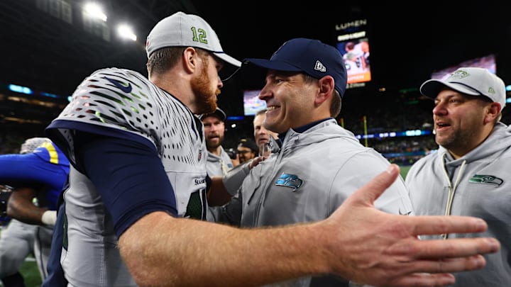 Dec 18, 2025; Seattle, Washington, USA; Seattle Seahawks head coach Mike MacDonald embraces quarterback Sam Darnold (14) after defeating the Los Angeles Rams in overtime at Lumen Field. Mandatory Credit: Kevin Ng-Imagn Images