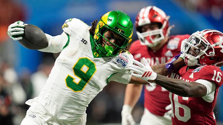 Jan 9, 2026; Atlanta, GA, USA; Oregon Ducks tight end Jamari Johnson (9) stiff arms Indiana Hoosiers defensive back Jah Jah Boyd (16) during the fourth quarter the 2025 Peach Bowl and semifinal game of the College Football Playoff at Mercedes-Benz Stadium. Mandatory Credit: Dale Zanine-Imagn Images