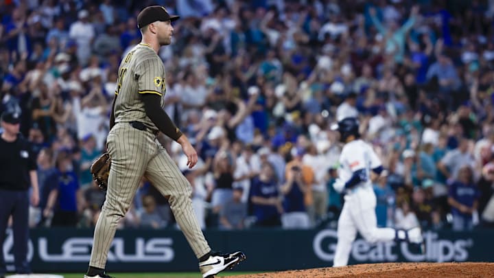 Aug 26, 2025; Seattle, Washington, USA; San Diego Padres pitcher Jason Adam (40) walks back to the mound after surrendering a three-run home run to Seattle Mariners third baseman Eugenio Suárez (28, background) during the fifth inning at T-Mobile Park. Mandatory Credit: Joe Nicholson-Imagn Images