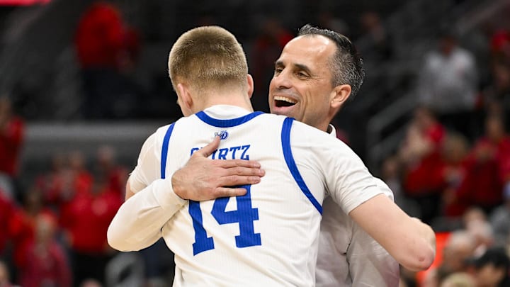 Mar 9, 2025; St. Louis, Missouri, USA; Drake Bulldogs head coach Ben McCollum hugs guard Bennett Stirtz (14) after defeating the Bradley Braves to win the Missouri Valley Conference Tournament Championship at Enterprise Center. Mandatory Credit: Jeff Curry-Imagn Images Mar 9, 2025; St. Louis, Missouri, USA; Drake Bulldogs head coach Ben McCollum hugs guard Bennett Stirtz (14) after defeating the Bradley Braves to win the Missouri Valley Conference Tournament Championship at Enterprise Center. Mandatory Credit: Jeff Curry-Imagn Images