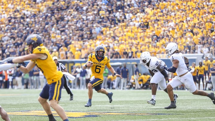 West Virginia Mountaineers quarterback Garrett Greene (6) runs the ball during the second quarter against the Penn State Nittany Lions at Mountaineer Field at Milan Puskar Stadium.