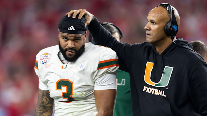 Jan 8, 2026; Glendale, AZ, USA; Miami Hurricanes defensive line coach Jason Taylor with defensive lineman Akheem Mesidor (3) against the Mississippi Rebels during the 2026 Fiesta Bowl and semifinal game of the College Football Playoff at State Farm Stadium. Mandatory Credit: Mark J. Rebilas-Imagn Images