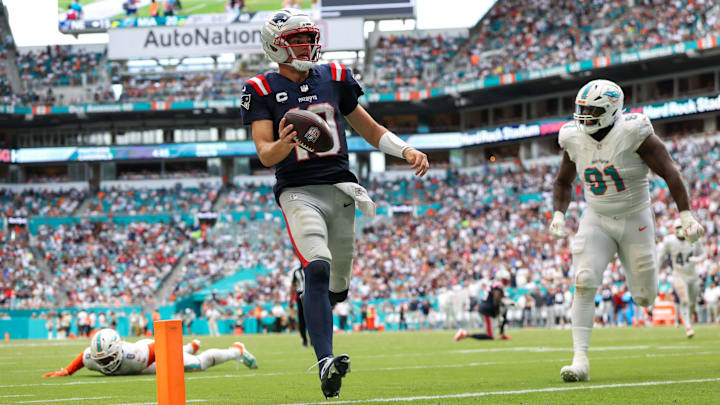 Sep 14, 2025; Miami Gardens, Florida, USA; New England Patriots quarterback Drake Maye (10) runs into the endzone for a touchdown against the Miami Dolphins in the third quarter at Hard Rock Stadium. Mandatory Credit: Nathan Ray Seebeck-Imagn Images