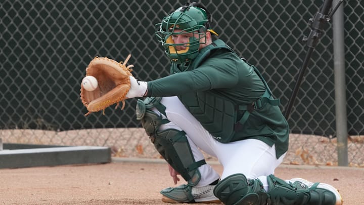 Feb 12, 2025; Mesa, AZ, USA; Oakland Athletics/ catcher Kyle McCann works out in the bullpen during spring training camp. Mandatory Credit: Rick Scuteri-Imagn Images