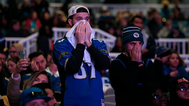 Garrett Johnson (87) and Daniel Cannady react to the sting of defeat as seconds tick off the clock