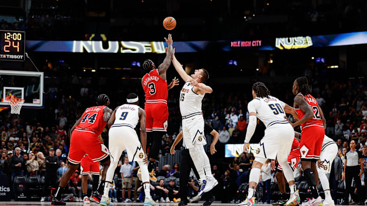 Oct 15, 2023; Denver, Colorado, USA; Chicago Bulls center Andre Drummond (3) wins the tipoff against Denver Nuggets center Nikola Jokic (15) as forward Patrick Williams (44) and forward Justin Holiday (9) and forward Aaron Gordon (50) and guard Ayo Dosunmu (12) look on in the first quarter at Ball Arena. Mandatory Credit: Isaiah J. Downing-Imagn Images