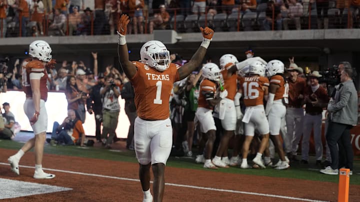 Texas Longhorns defensive lineman Colin Simmons reacts after a fumble was recovered for a touchdown during the second half against the Arkansas Razorbacks Texas Longhorns defensive lineman Colin Simmons reacts after a fumble was recovered for a touchdown during the second half against the Arkansas Razorbacks