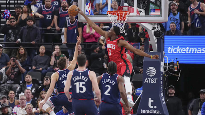 Apr 9, 2025; Inglewood, California, USA; Houston Rockets center N'Faly Dante (3) block Los Angeles Clippers guard Bogdan Bogdanovic (10) in the second half at Intuit Dome. Mandatory Credit: Kirby Lee-Imagn Images