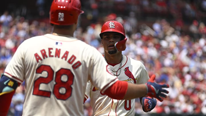 Jul 13, 2024; St. Louis, Missouri, USA; St. Louis Cardinals shortstop Masyn Winn (0) celebrates with third baseman Nolan Arenado (28) after scoring off a single from catcher Willson Contreras (not pictured) against the Chicago Cubs during the first inning at Busch Stadium. Mandatory Credit: Jeff Le-Imagn Images