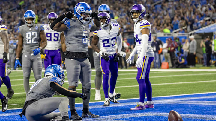 Jan 7, 2024; Detroit, Michigan, USA; Detroit Lions running back David Montgomery (5) flexes his muscles after scoring a touchdown against the Minnesota Vikings during second half at Ford Field. Mandatory Credit: David Reginek-Imagn Images