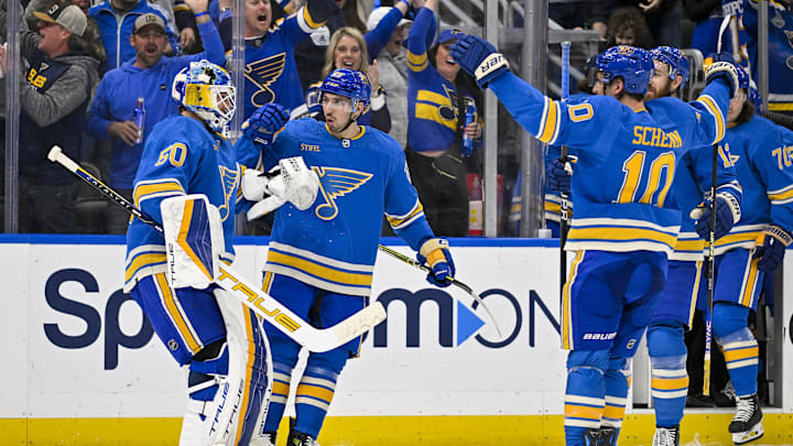 Mar 16, 2024; St. Louis, Missouri, USA;  St. Louis Blues center Jordan Kyrou (25) celebrates with goaltender Jordan Binnington (50) after the Blues defeated the Minnesota Wild in shoot outs at Enterprise Center. Mandatory Credit: Jeff Curry-Imagn Images