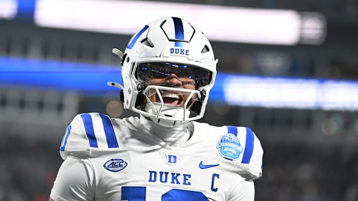 Dec 6, 2025; Charlotte, NC, USA; Duke Blue Devils quarterback Darian Mensah (10) celebrates after the Blue Devils score a touchdown in overtime during the  ACC Championship game at Bank of America Stadium. Mandatory Credit: Bob Donnan-Imagn Images