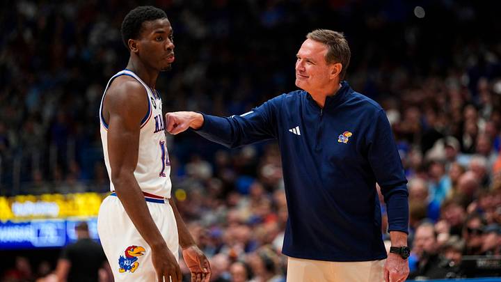 Jan 13, 2026; Lawrence, Kansas, USA; Kansas Jayhawks head coach Bill Self talks with guard Melvin Council Jr. (14) during the second half against the Iowa State Cyclones at Allen Fieldhouse. Mandatory Credit: Jay Biggerstaff-Imagn Images