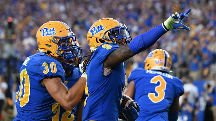 Sep 14, 2024; Pittsburgh, Pennsylvania, USA; Pittsburgh Panthers linebacker Kyle Louis celebrates with Brandon George (30) after intercepting West Virginia Mountaineers quarterback Garrett Greene (6) in the fourth quarter at Acrisure Stadium. Mandatory Credit: Barry Reeger-Image Images