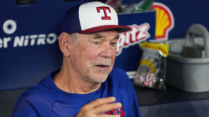 Texas Rangers manager Bruce Bochy (15) talks with the media in the dugout during batting practice before a game against the Toronto Blue Jays.