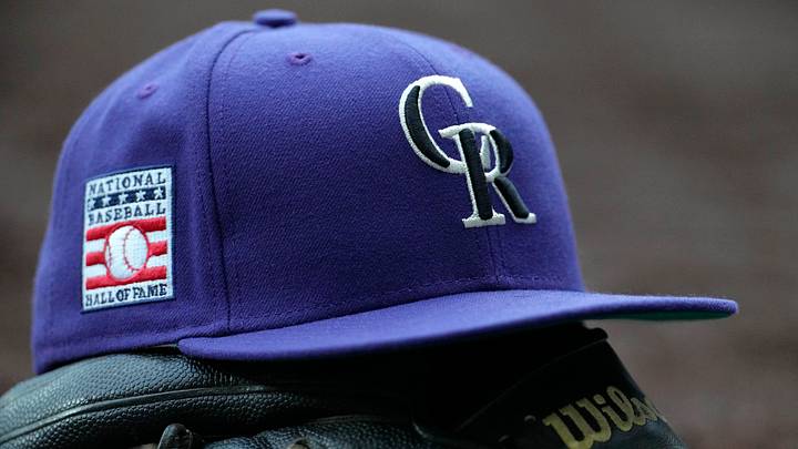 Colorado Rockies hat on top of a glove. Credit: Michael McLoone-Imagn Images
