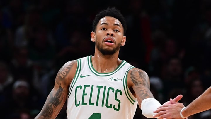 Nov 23, 2025; Boston, Massachusetts, USA; Boston Celtics guard Anfernee Simons (4) is congratulated by guard Derrick White (9) after a basket during the first half at TD Garden. Mandatory Credit: Bob DeChiara-Imagn Images