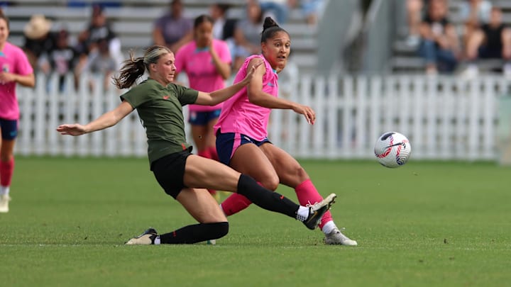 Feb 24, 2024; Indio, California, USA;  San Diego Wave forward Elyse Bennett is fouled from behind by Portland Thorns defender Kelli Hubly (20) at PayPal Park. Mandatory Credit: Abe Arredondo-USA TODAY Sports
