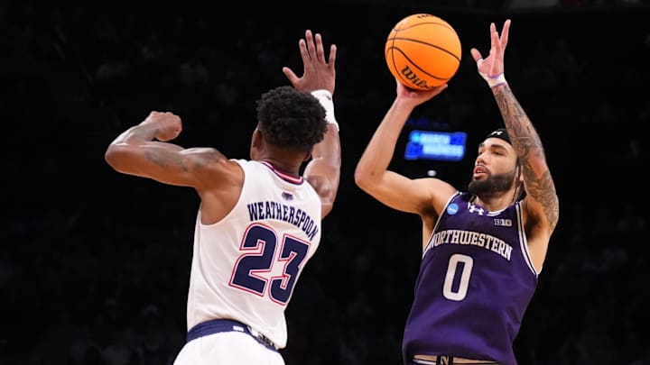 March 22, 2024, Brooklyn, NY, USA;  Northwestern Wildcats guard Boo Buie (0) shoots against Florida Atlantic Owls guard Brandon Weatherspoon (23) in the first round of the 2024 NCAA Tournament at the Barclays Center. Mandatory Credit: Robert Deutsch-Imagn Images