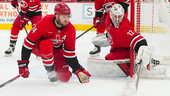 Jan 16, 2026; Raleigh, North Carolina, USA;  Carolina Hurricanes goaltender Brandon Bussi (32) and Carolina Hurricanes defenseman Jaccob Slavin (74) watch the play against the Florida Panthers during the second period at Lenovo Center. Mandatory Credit: James Guillory-Imagn Images